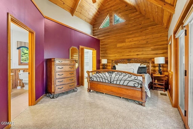 bedroom featuring wood walls, wooden ceiling, high vaulted ceiling, and connected bathroom