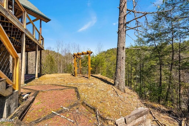 view of yard featuring a forest view