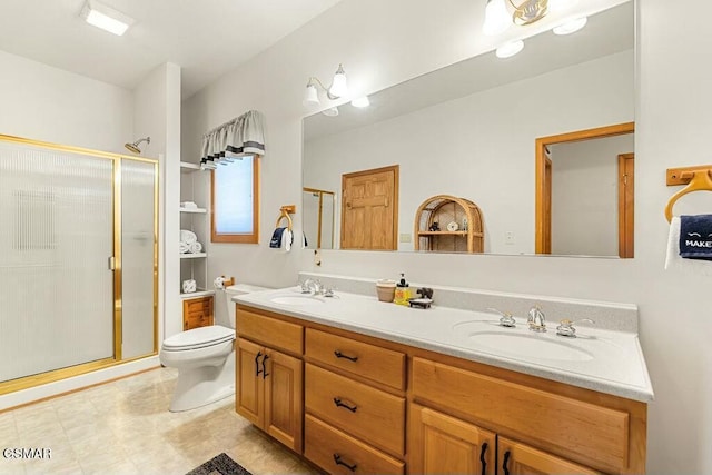 bathroom with double vanity, a stall shower, toilet, and a sink