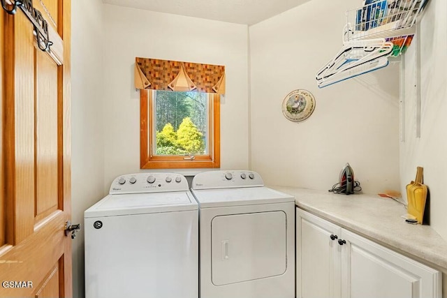 laundry room featuring cabinet space and washing machine and dryer