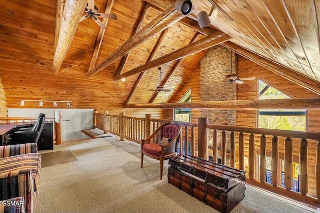 interior space featuring wooden walls, carpet, beamed ceiling, wooden ceiling, and high vaulted ceiling