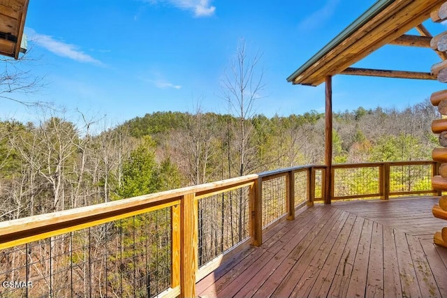 wooden deck featuring a view of trees