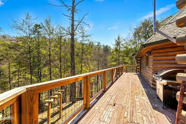 wooden deck with a view of trees