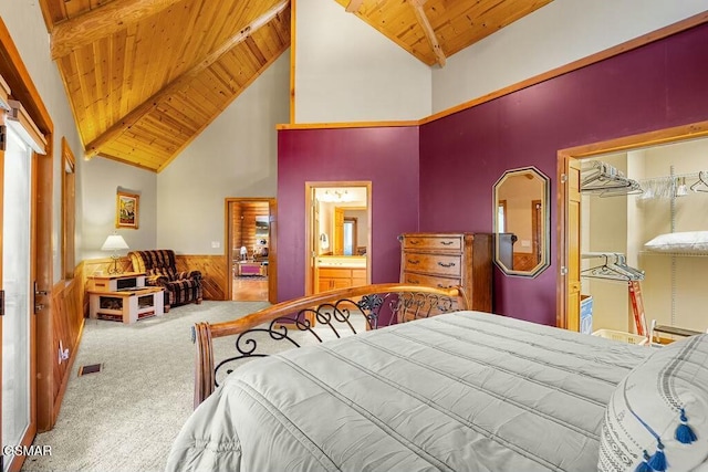 bedroom with visible vents, a wainscoted wall, wood ceiling, lofted ceiling with beams, and carpet floors