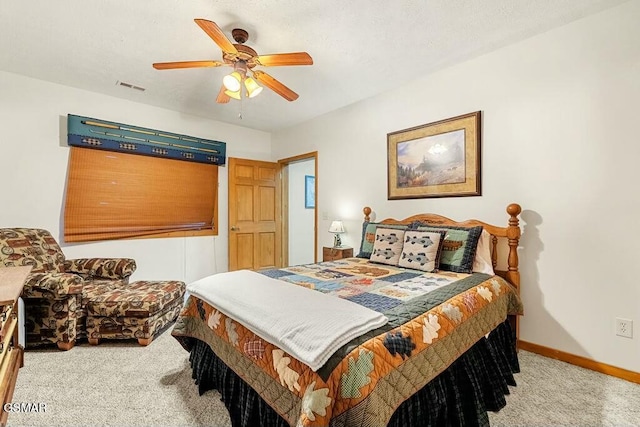 carpeted bedroom featuring a ceiling fan, baseboards, visible vents, and a textured ceiling