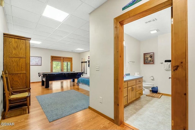 game room with baseboards, visible vents, and light wood finished floors