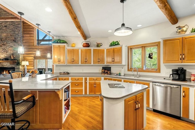 kitchen featuring a sink, a stone fireplace, dishwasher, beamed ceiling, and a center island