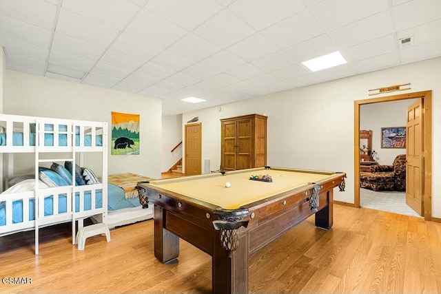 recreation room featuring billiards, light wood-style flooring, and a paneled ceiling