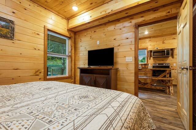 bedroom featuring multiple windows and wood walls