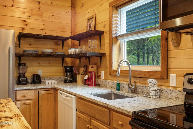 kitchen featuring black electric range oven, wooden walls, sink, and white dishwasher