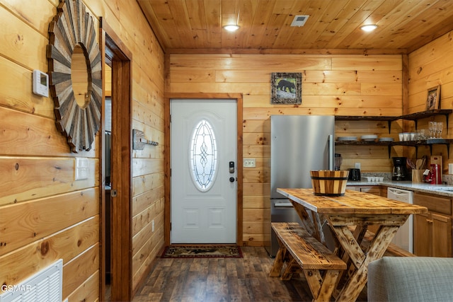 entrance foyer featuring wood walls, wooden ceiling, and dark wood-type flooring