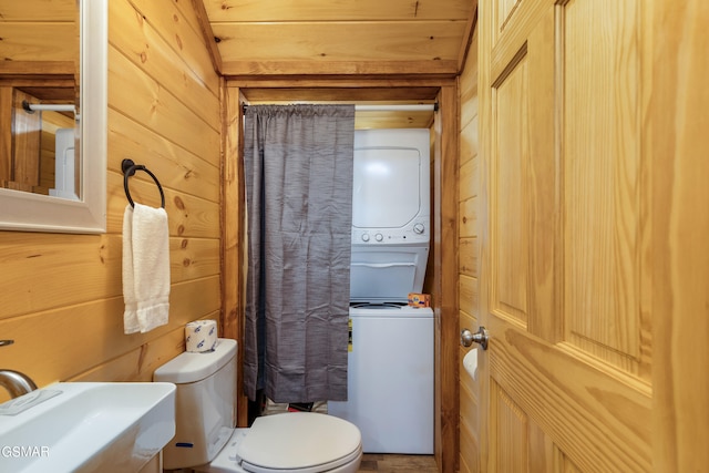 bathroom with wooden ceiling, toilet, wooden walls, and sink