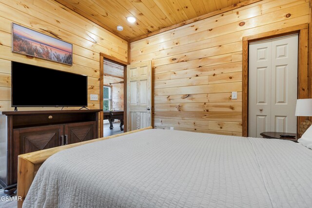 bedroom with wooden walls and wooden ceiling