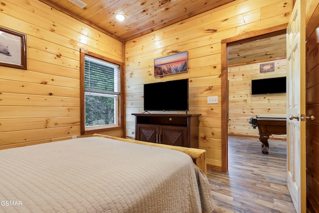 bedroom with wood walls, billiards, wood ceiling, and hardwood / wood-style flooring