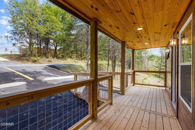 unfurnished sunroom with wood ceiling