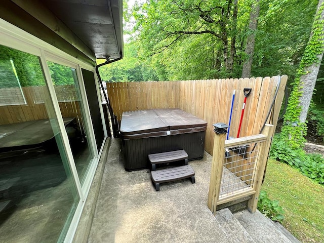 view of patio / terrace with a hot tub