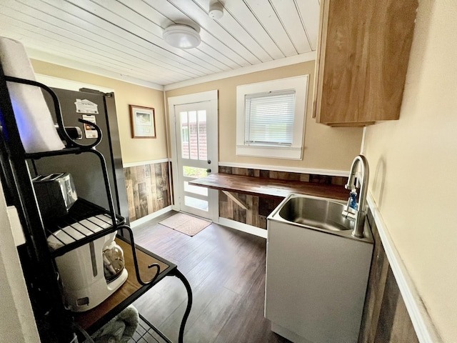 kitchen with sink, dark hardwood / wood-style flooring, wooden ceiling, and crown molding