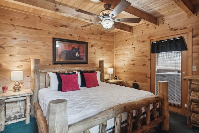 carpeted bedroom with wood walls, beamed ceiling, ceiling fan, and wood ceiling