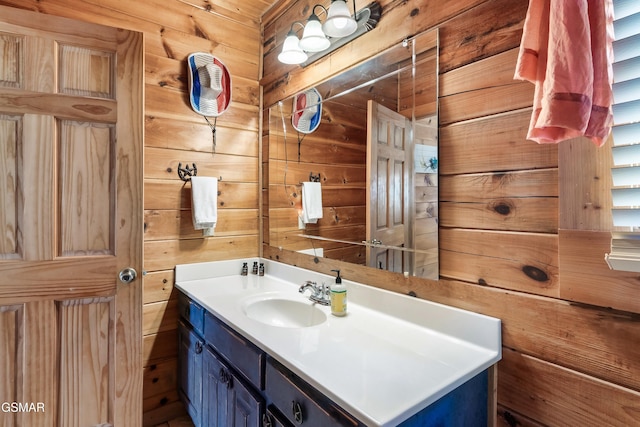 bathroom with vanity and wooden walls