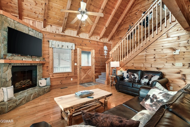 living room featuring wooden walls, beamed ceiling, wood ceiling, and hardwood / wood-style flooring