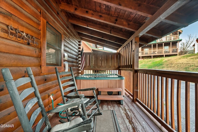 wooden deck featuring a hot tub