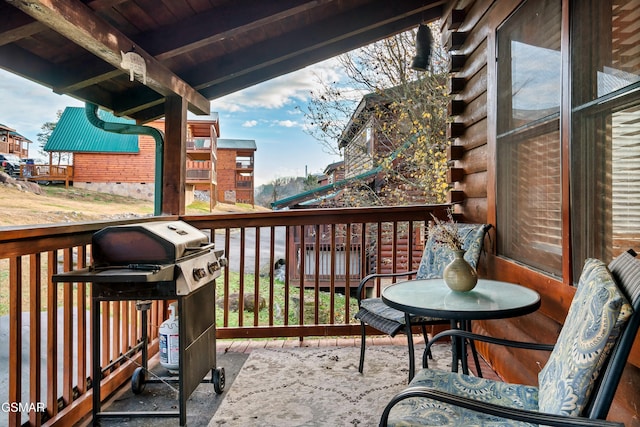 wooden balcony featuring area for grilling and a wooden deck