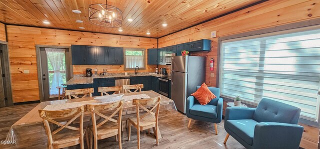 1531 Bear Valley Rd, Sevierville, TN 37876 - dining space featuring wooden walls, wood ceiling, recessed lighting, light wood-type flooring, and a chandelier