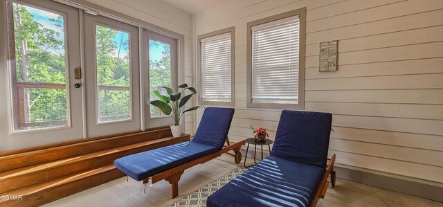 1531 Bear Valley Rd, Sevierville, TN 37876 - sitting room with plenty of natural light, wood walls, and wood finished floors
