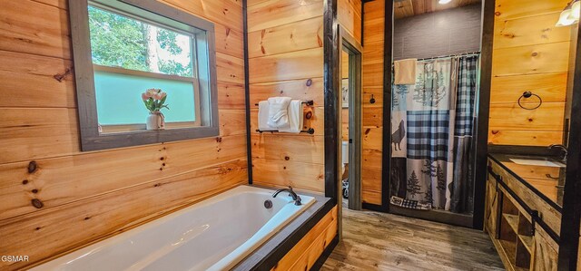 1531 Bear Valley Rd, Sevierville, TN 37876 - full bathroom featuring a bath, wooden walls, wood finished floors, curtained shower, and vanity