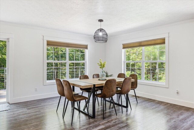 dining room with dark wood-type flooring and ornamental molding