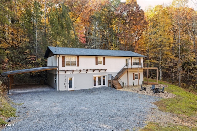 view of front of property with french doors and a carport