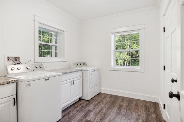 laundry area featuring washing machine and dryer, plenty of natural light, cabinets, and ornamental molding