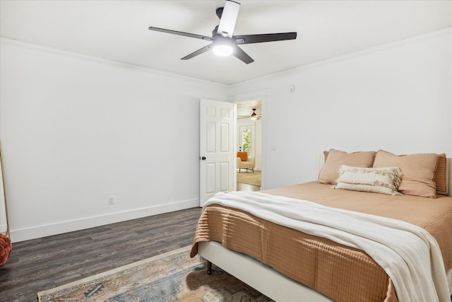 bedroom with ceiling fan, dark hardwood / wood-style floors, and crown molding