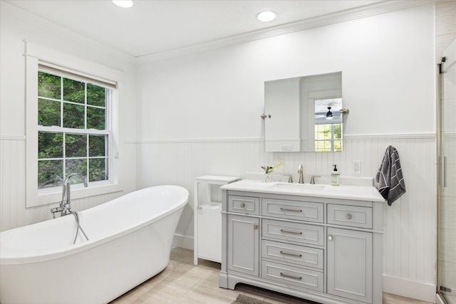 bathroom featuring vanity, ornamental molding, and a tub to relax in