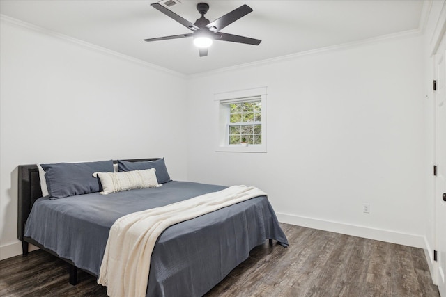 bedroom with ornamental molding, ceiling fan, and dark wood-type flooring