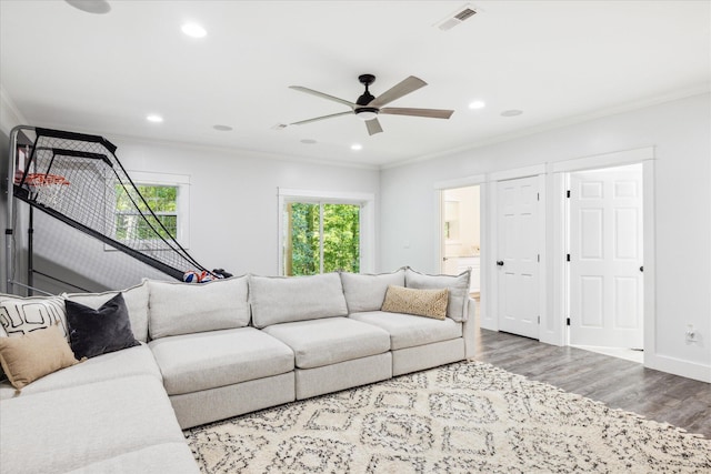 living room featuring ceiling fan, crown molding, and wood-type flooring