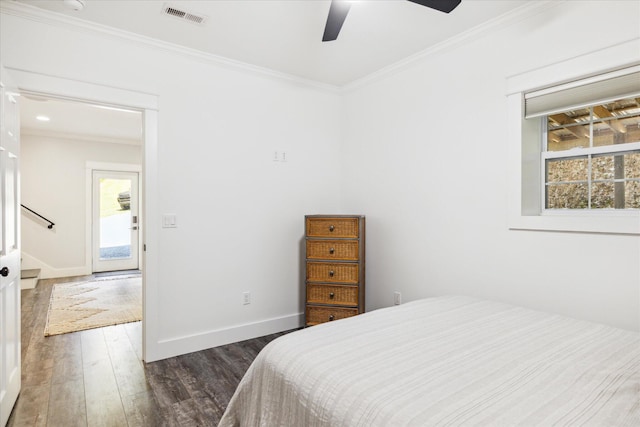 bedroom with ceiling fan, crown molding, and dark wood-type flooring