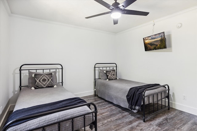 bedroom featuring dark hardwood / wood-style flooring, ceiling fan, and ornamental molding