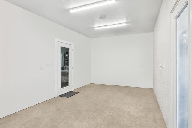 unfurnished room featuring light carpet