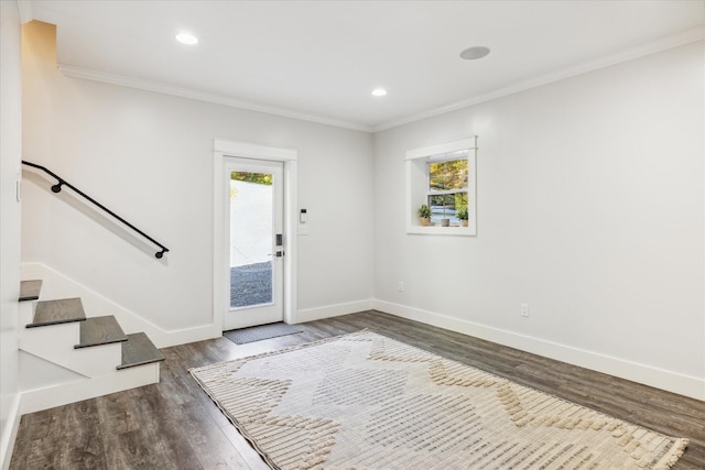 foyer featuring crown molding and dark wood-type flooring