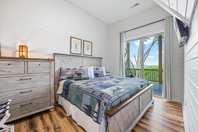 bedroom featuring access to outside and dark hardwood / wood-style floors