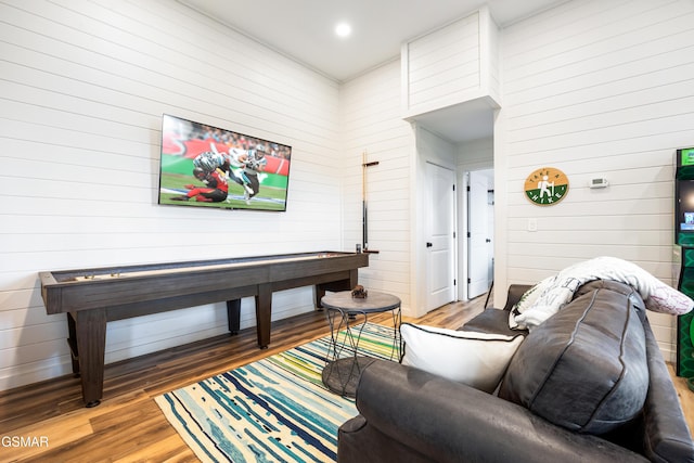 living room with wood walls and hardwood / wood-style floors