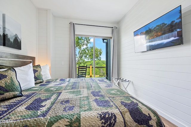 bedroom featuring hardwood / wood-style flooring and access to outside