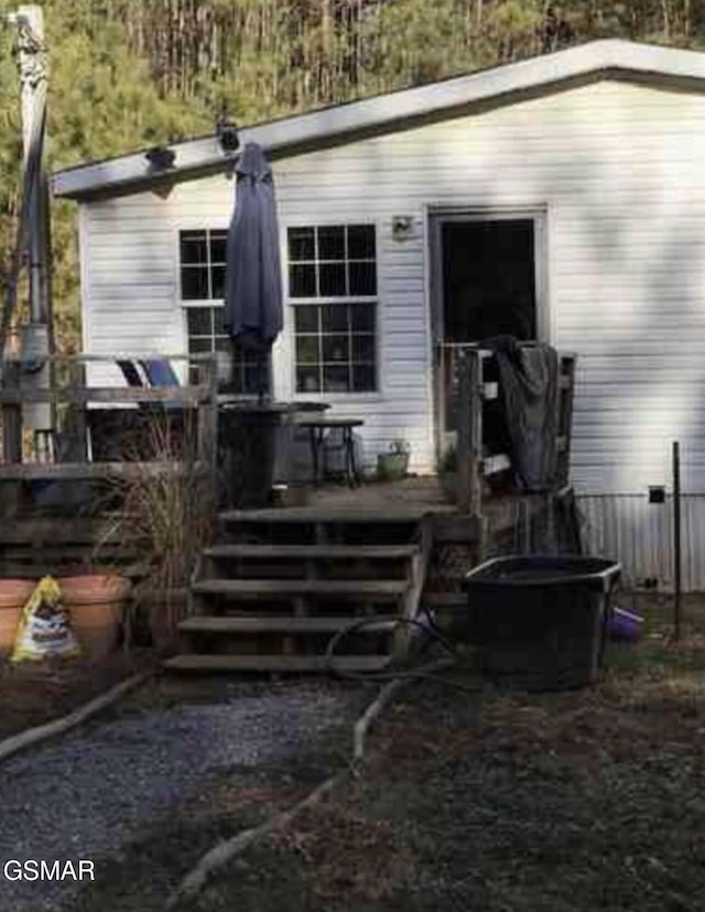 rear view of house with a wooden deck