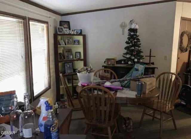 dining space with crown molding