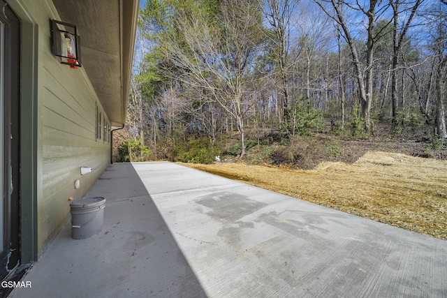 view of patio featuring a wooded view