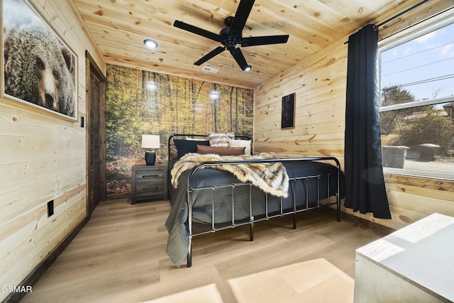 bedroom with wooden ceiling, wooden walls, wood finished floors, and visible vents