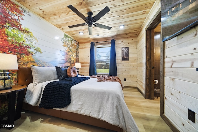 bedroom with a ceiling fan, wood finished floors, wood ceiling, and wood walls