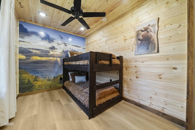 bedroom with wood finished floors, recessed lighting, wooden walls, wooden ceiling, and ceiling fan