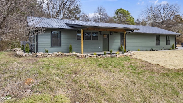 view of front of house with a front yard and metal roof